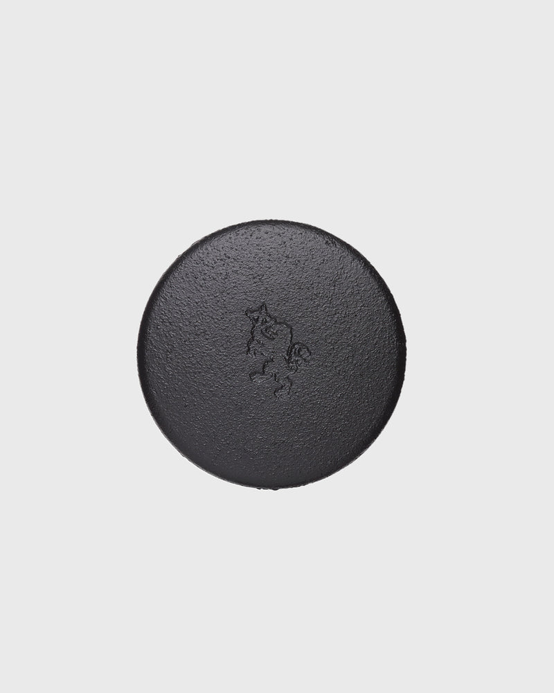 Black cast iron 2-part spice grinder with internal teeth for crushing herbs and spices
