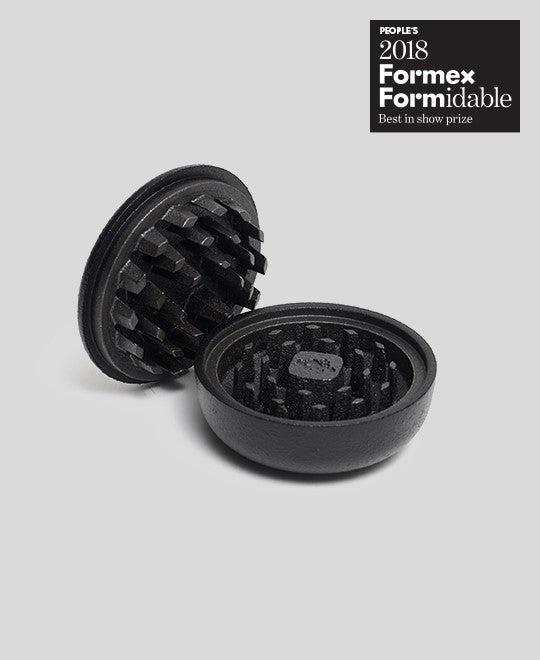 Black cast iron 2-part spice grinder with internal teeth for crushing herbs and spices