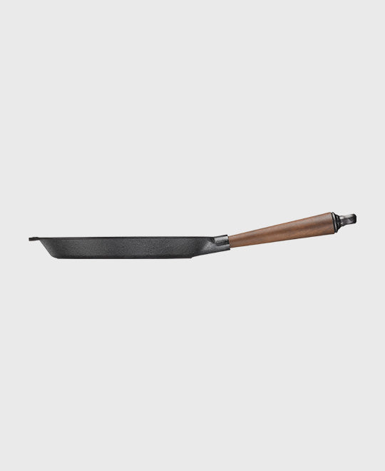 Side profile of Skeppshult cast iron frying pan showing pan depth and walnut handle