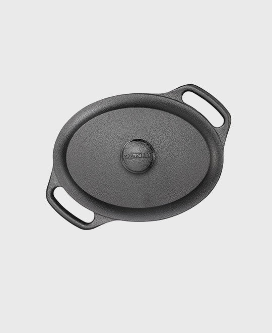 Black cast iron casserole 2 L oval with iron lid and two iron handles