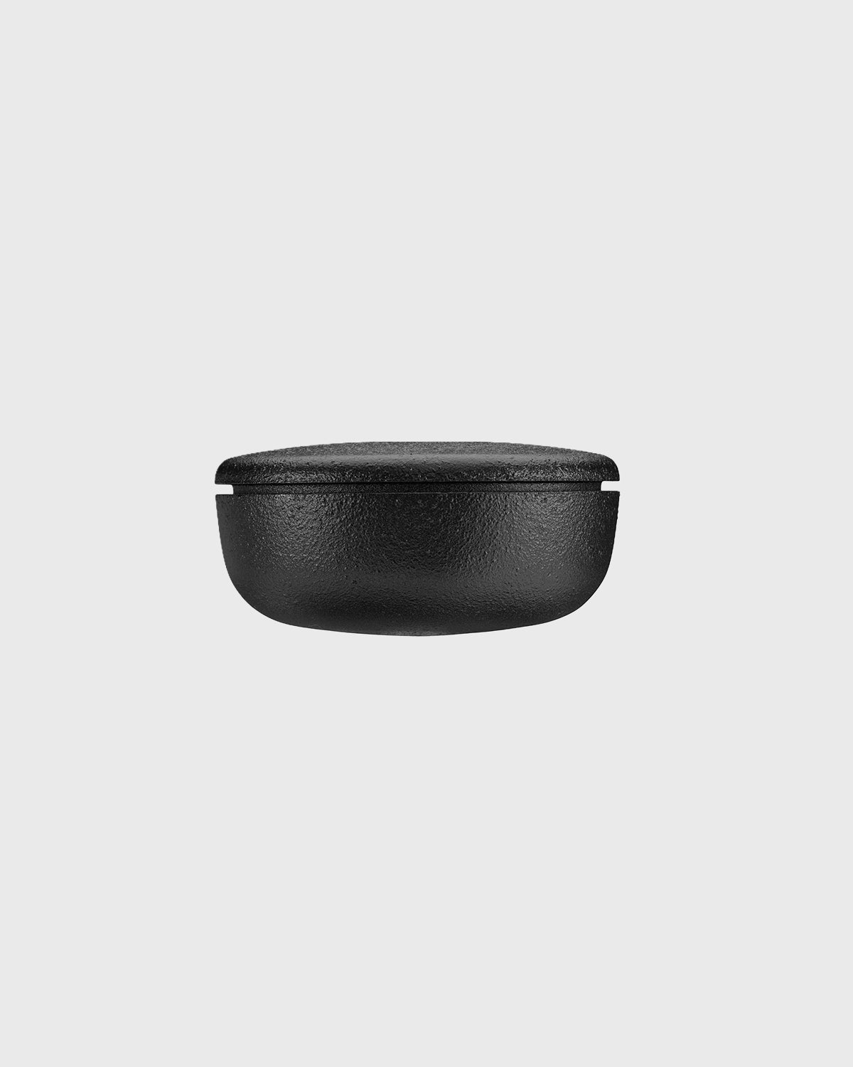 Black cast iron 2-part spice grinder with internal teeth for crushing herbs and spices