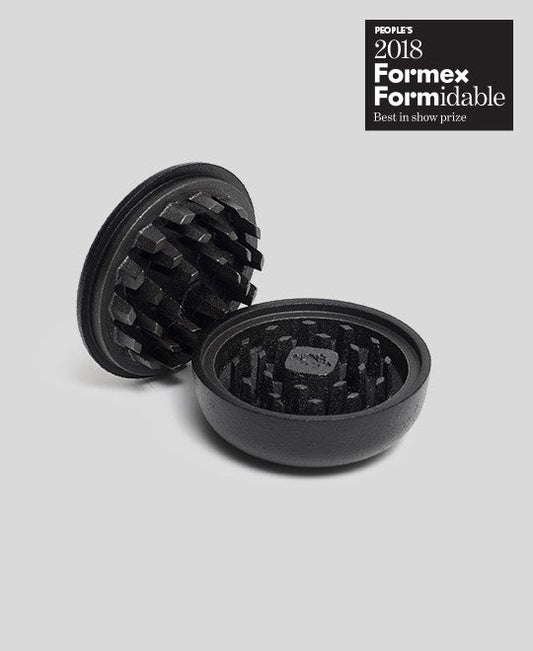 Black cast iron 2-part spice grinder with internal teeth for crushing herbs and spices