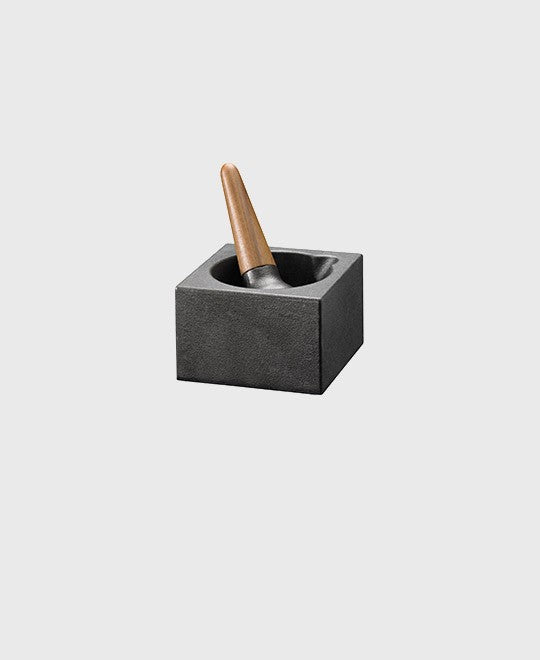 Black cast iron mortar and pestle cubic featuring walnut wood handle